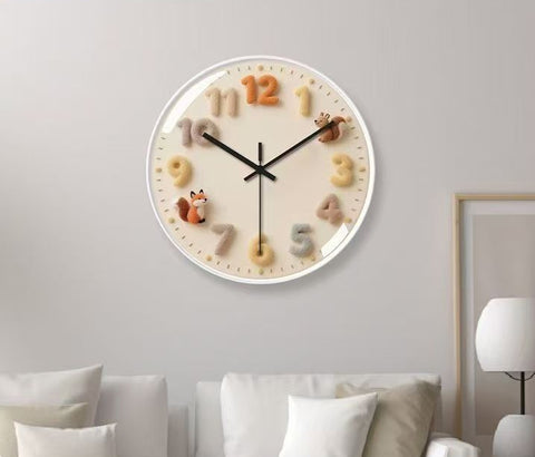 Decorative wall clock with animal designs on a light gray wall.